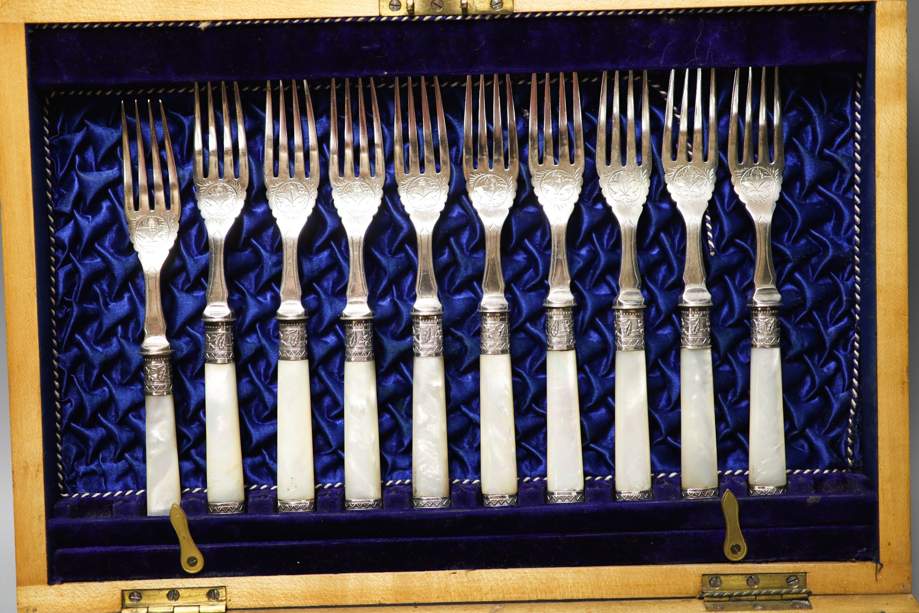 A George V cased set of six pairs of mother of pearl handled silver dessert eaters, Sheffield, 1912 and a plated part set.